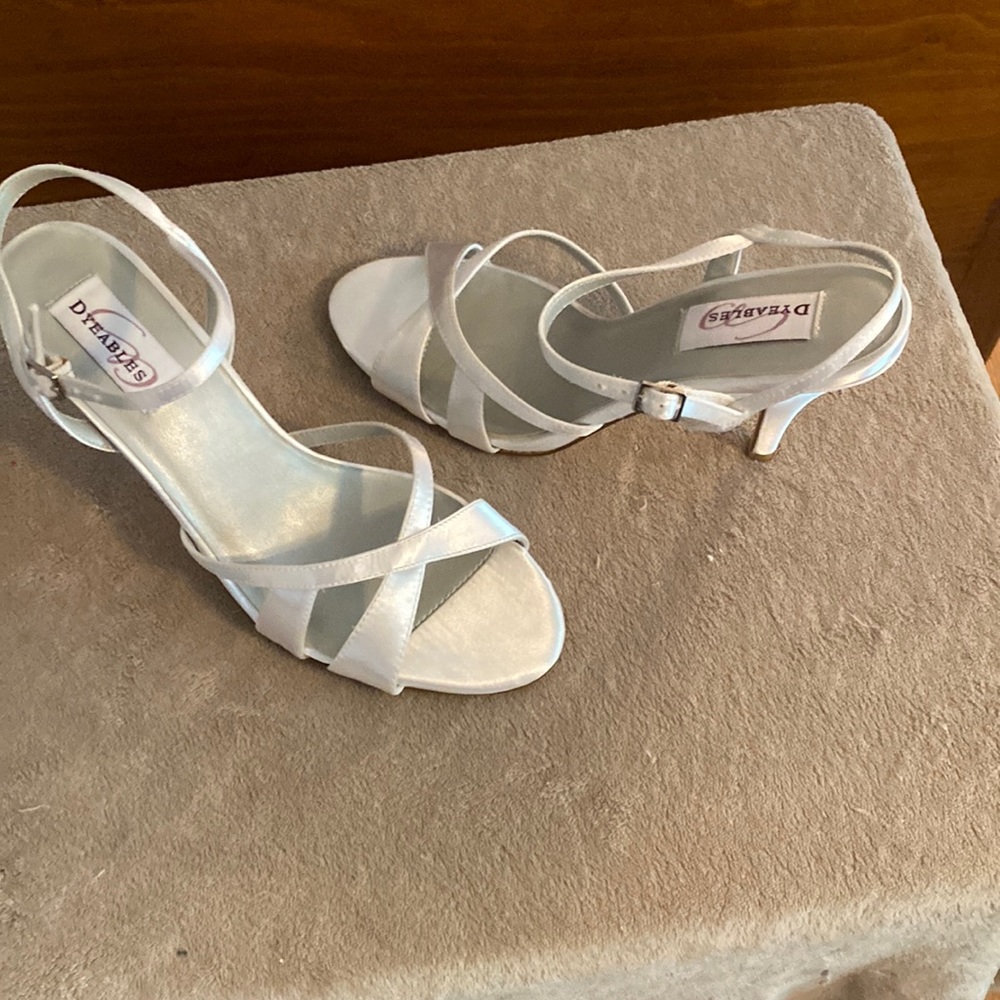 White satin sandal in a 9 and 1/2. Shoe has a 3 inch heel The shoe is new